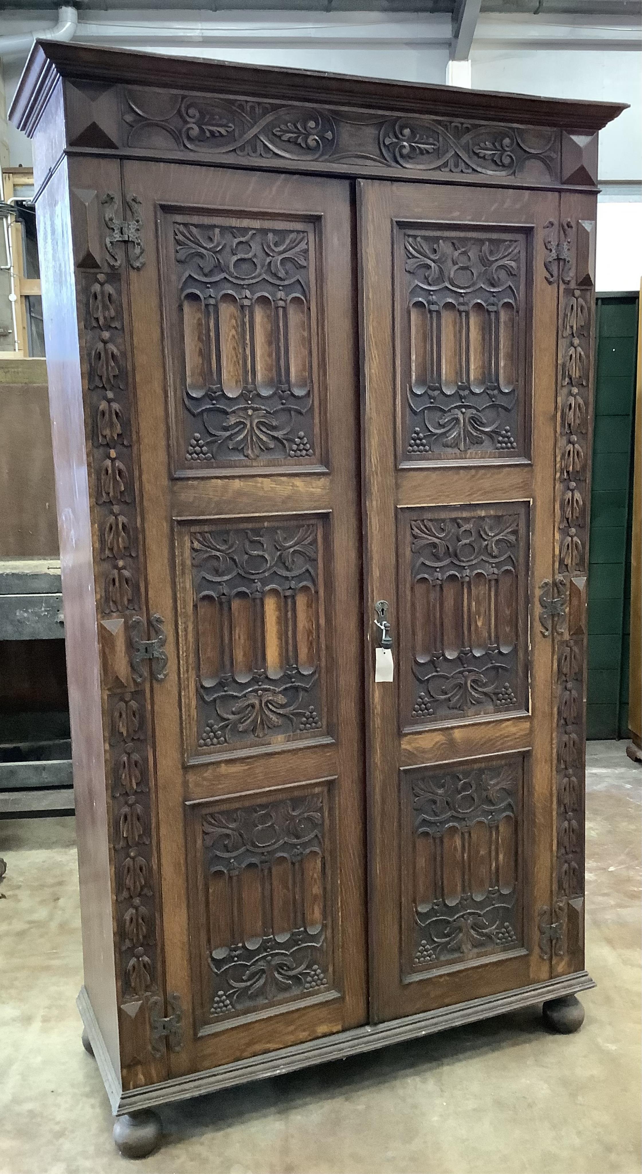 A 17th century style carved oak wardrobe, width 112cm, depth 46cm, height 197cm. Condition - fair